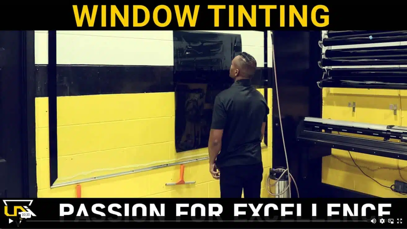 a man standing in front of a window tinting